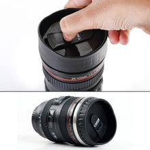 Stainless steel coffee mug with a plastic camera lens appearance, displaying the detailed design