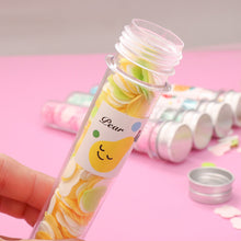 Test tube containing flower-shaped paper soap strips for travel.